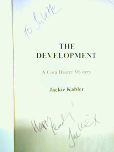 The Development. A Cora Baxter Mystery 